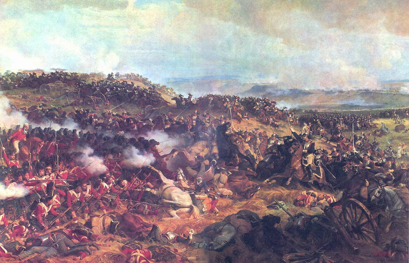 Painting of the Battle of Waterloo showing a large military clash: infantry, cavalry, cannons, smoke and fallen soldiers across a sprawling battlefield.