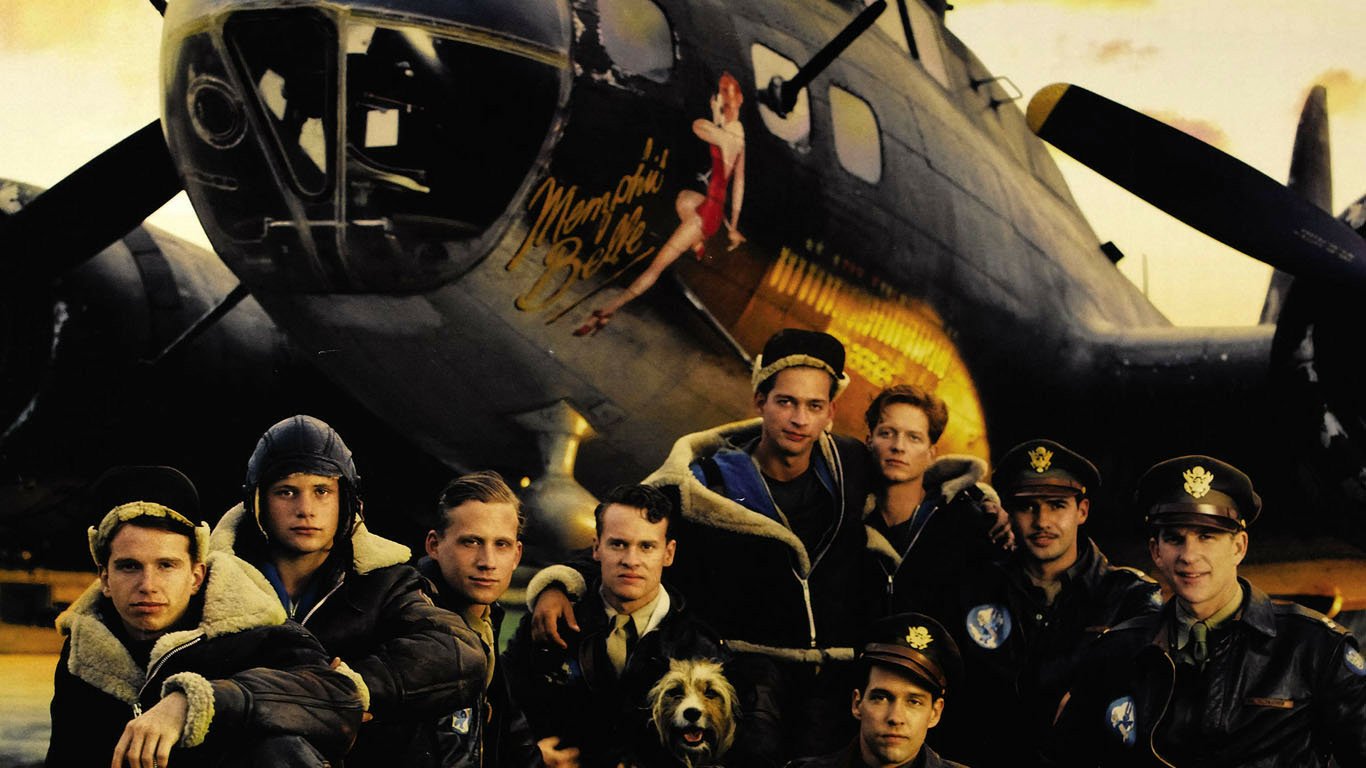 Promotional still for the movie Memphis Belle: a World War II B‑17 bomber with nose art and its aircrew posed in front of the aircraft.