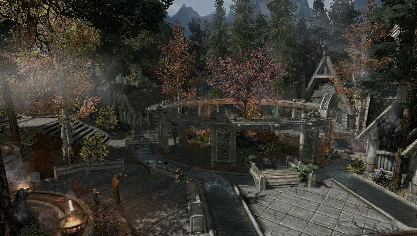 Whiterun from The Elder Scrolls V: Skyrim — the open city market and timber buildings backed by pine-covered hills.