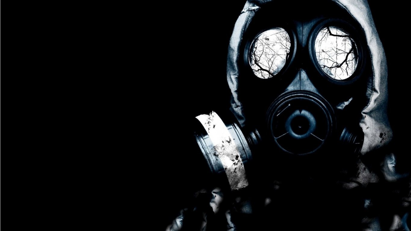 A dark figure wearing a gas mask looms against a black background, reflecting eerie light in its lenses, enhancing the sense of mystery and foreboding.