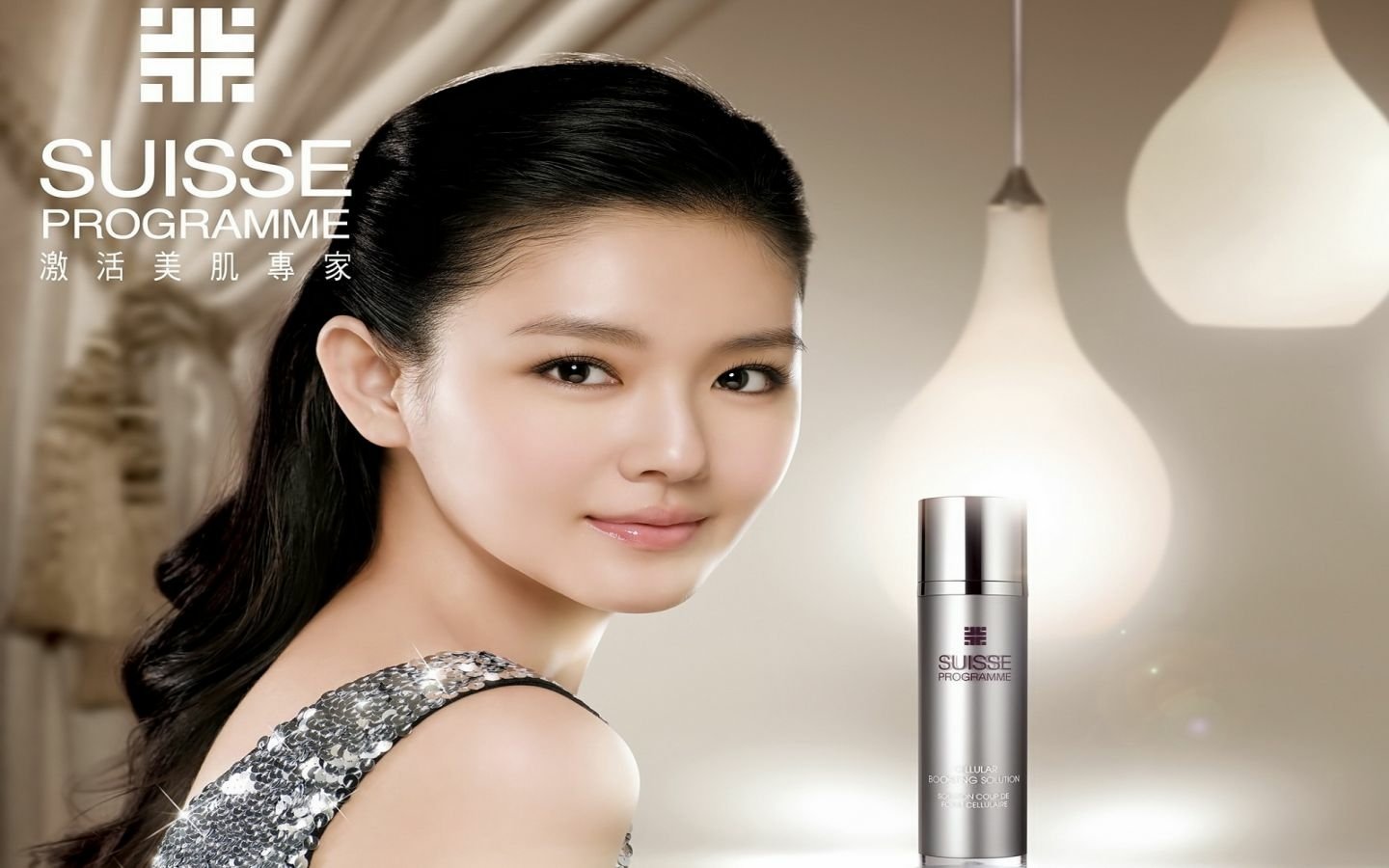 Taiwanese singer and actress Barbie Hsu poses elegantly with a skincare product, showcasing her beauty in a softly lit setting.