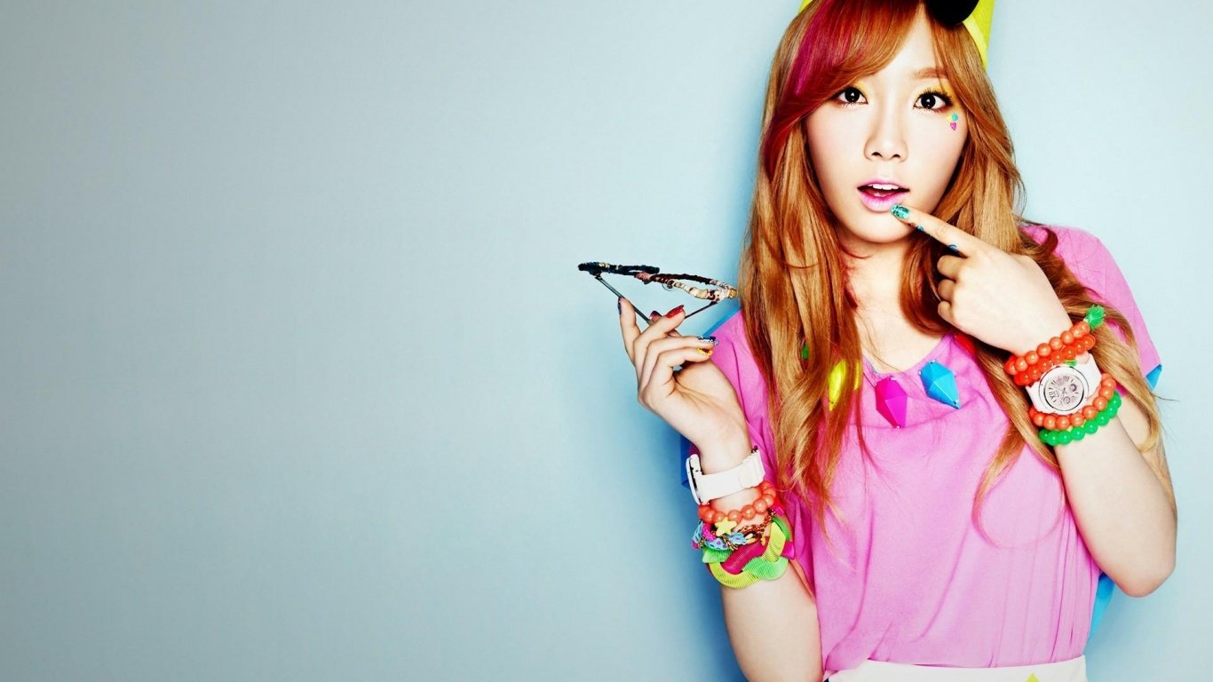 Kim Tae-yeon, Korean actress, dancer, TV presenter, and singer from Girls' Generation (SNSD), poses with vibrant accessories and a playful expression.
