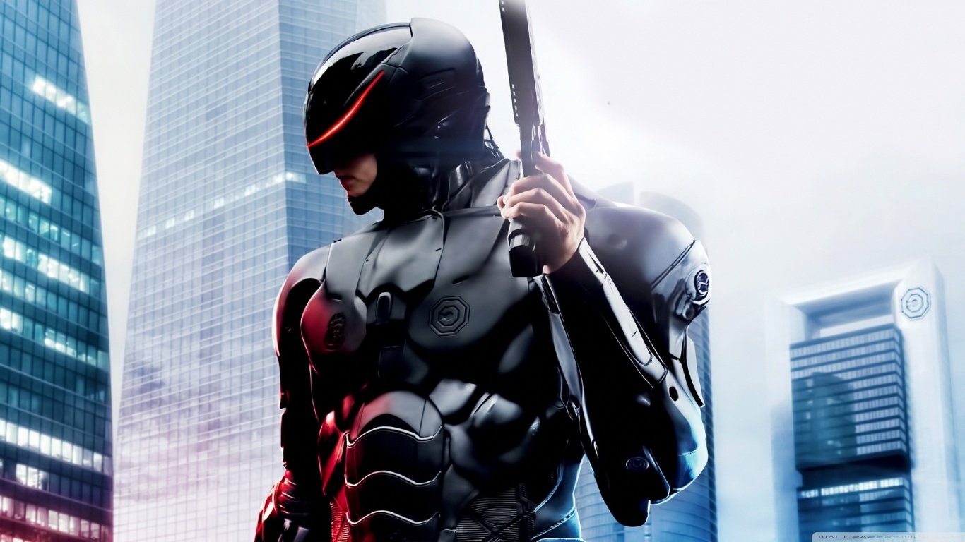 RoboCop from the 2014 movie stands in a futuristic cityscape, clad in sleek black armor and holding a weapon.