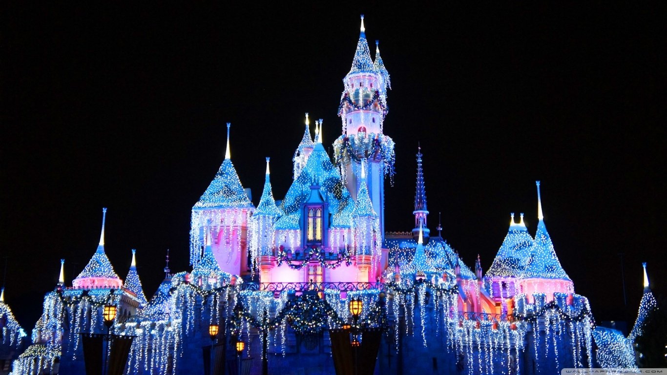 A beautifully lit Disneyland castle adorned with sparkling lights, showcasing Disney's enchanting charm against a night sky.