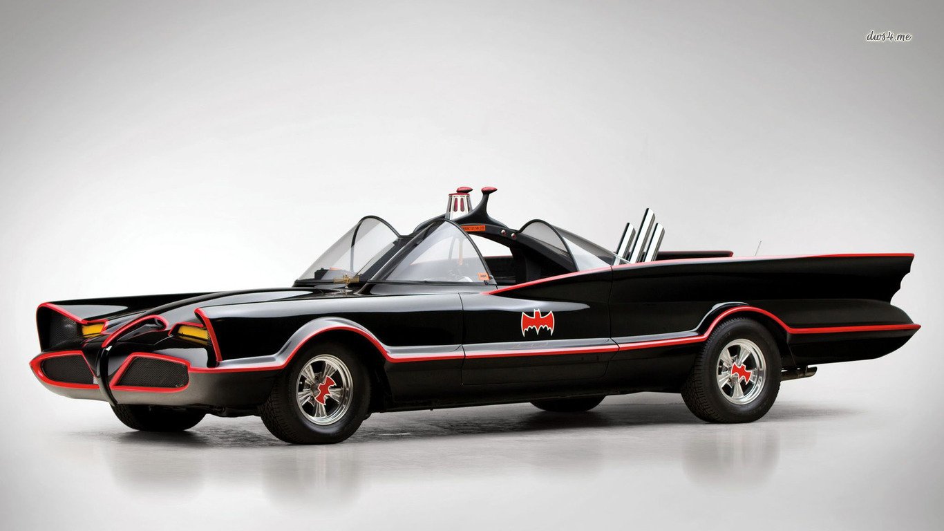 Classic Batmobile vehicle based on the Lincoln Futura, featuring its iconic black and red design with bat motifs and futuristic styling.
