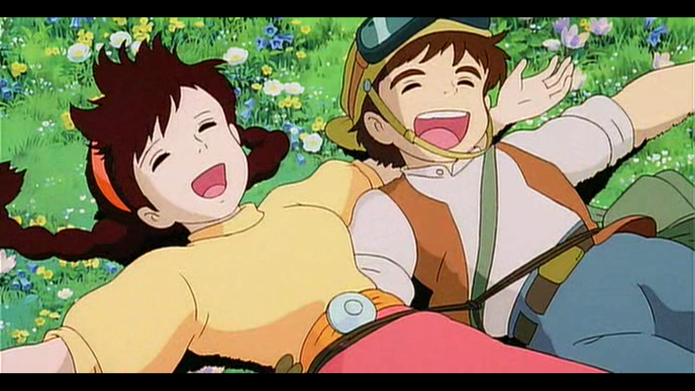 Two joyful characters from the anime Laputa: Castle in the Sky lie on a grassy field filled with flowers, smiling and enjoying a peaceful moment together.