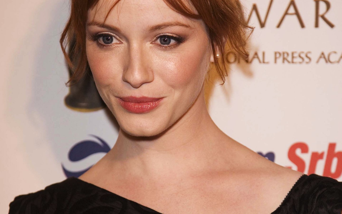Actress Christina Hendricks, known for Mad Men, poses with a subtle smile at a press event.