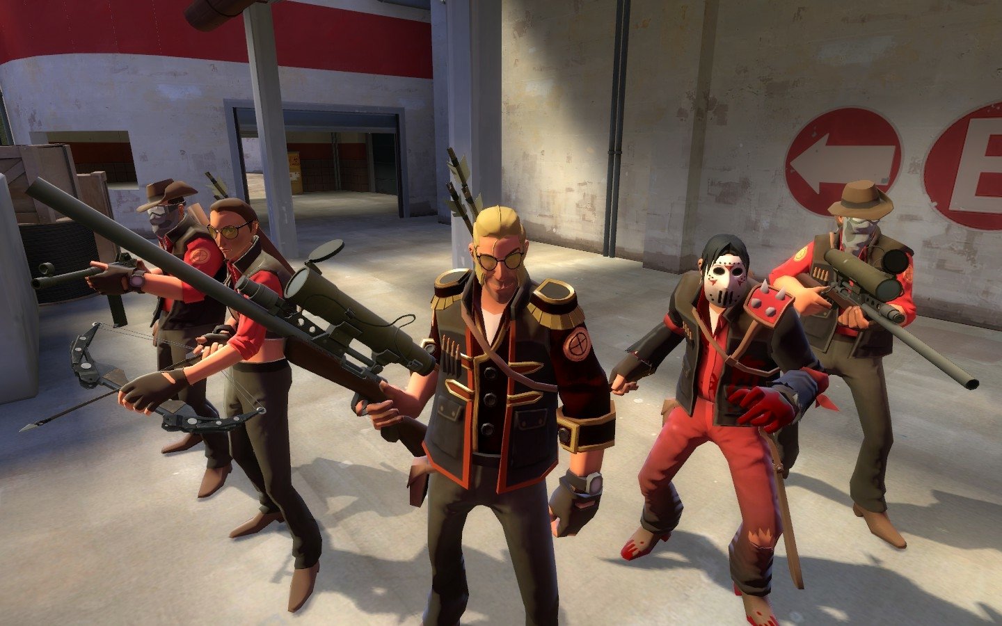 Team Fortress 2 video game scene: five characters armed with guns pose together in a concrete, industrial room.