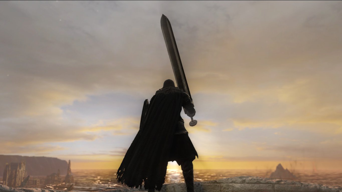 A lone warrior clad in dark armor raises a massive sword against a vast, fiery sunset landscape in the video game Dark Souls II.