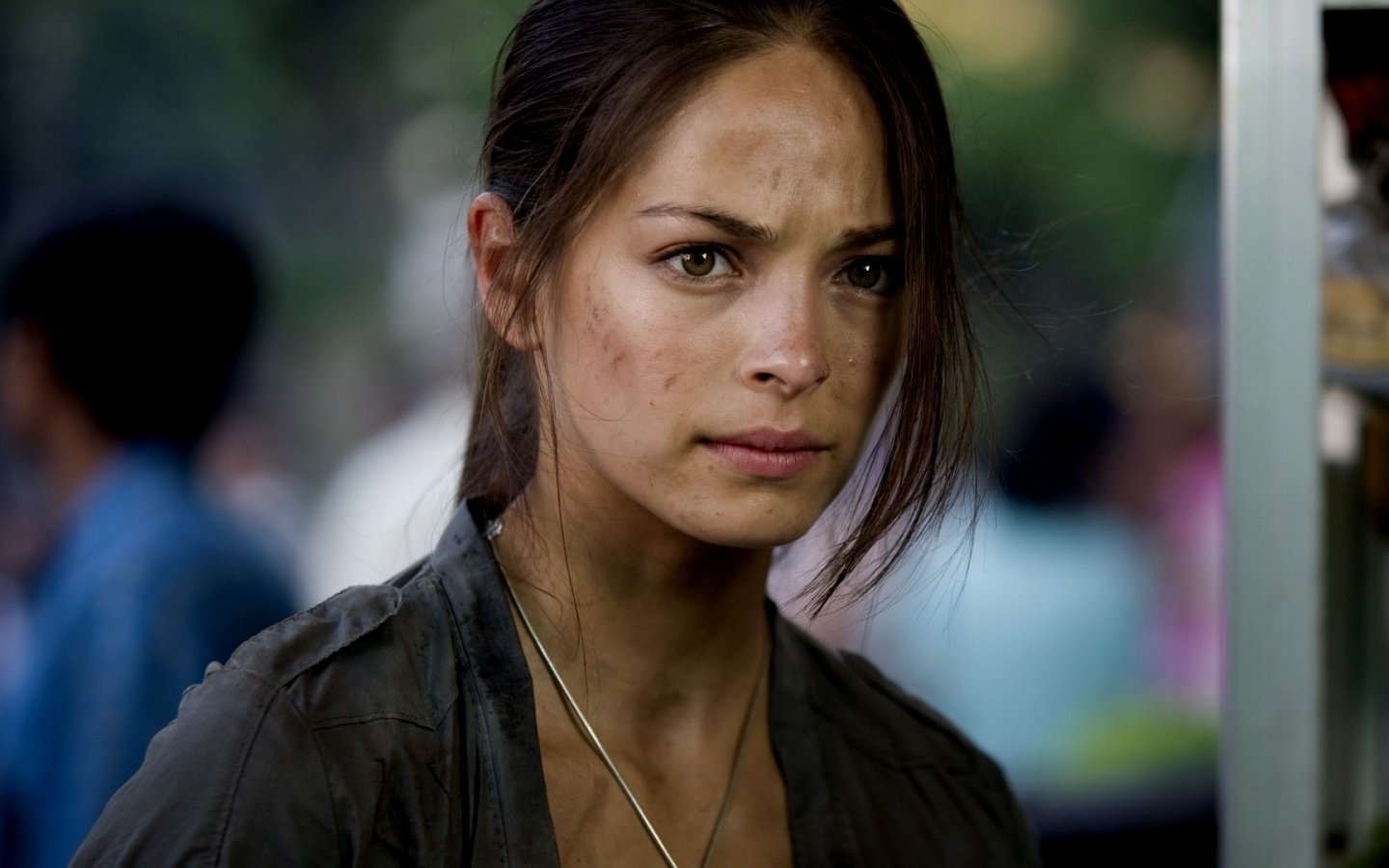 Kristin Kreuk in a scene from the movie Street Fighter: The Legend of Chun-Li, with a serious expression and slightly dirty face.