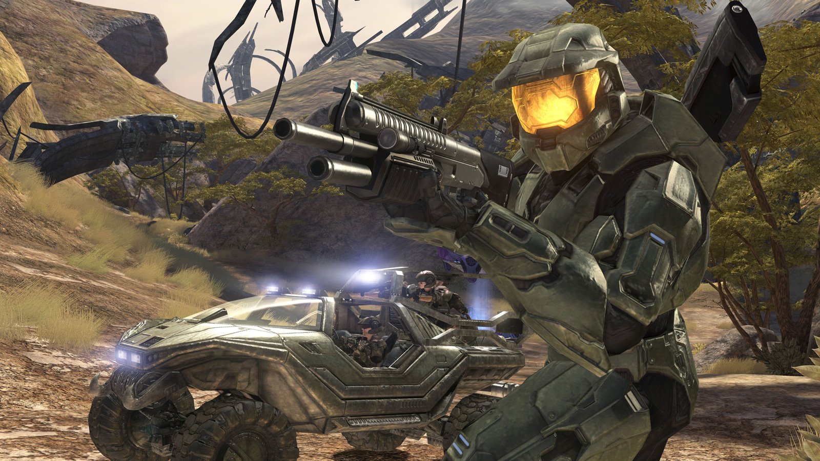 A soldier in armor holds a weapon, standing beside an M12 Warthog vehicle from the video game Halo, set against a rugged terrain.