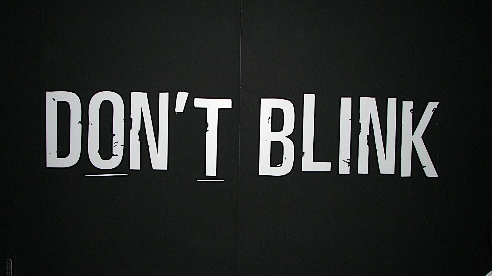 Image of the phrase DON'T BLINK in bold white letters against a black background, referencing a memorable line from the TV show Doctor Who (2005).
