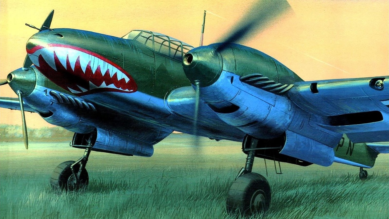 A military aircraft with shark mouth nose art is shown parked on grass at dusk, featuring twin propellers and a cockpit canopy.