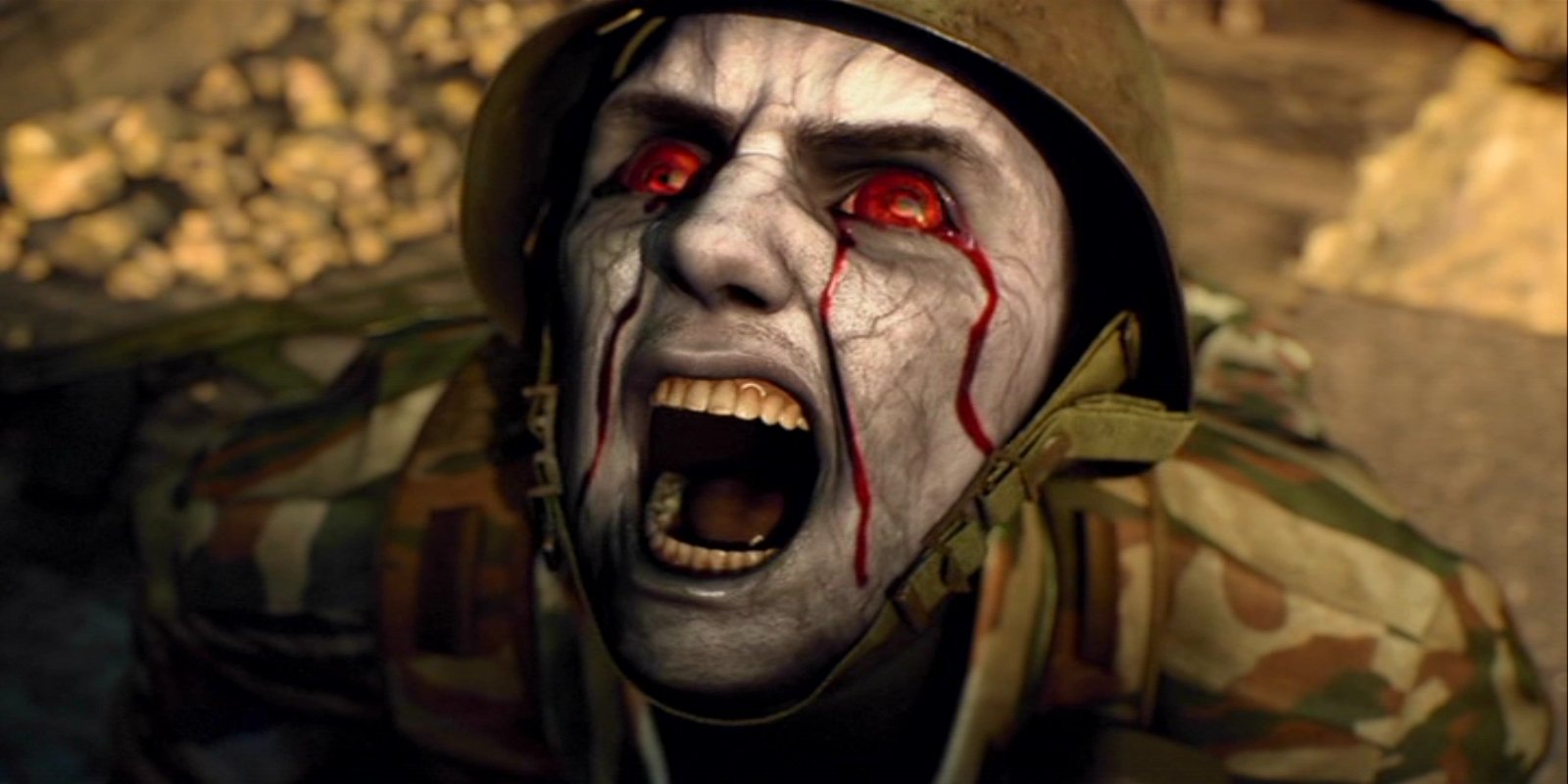 Still from the movie Resident Evil: Damnation: a zombified soldier with pale, cracked skin, bleeding red eyes and mouth wide open in a scream.