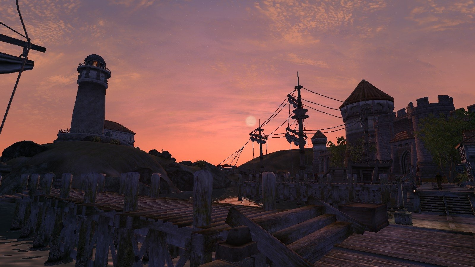 A sunset view over a coastal town with wooden docks in the video game The Elder Scrolls IV: Oblivion.