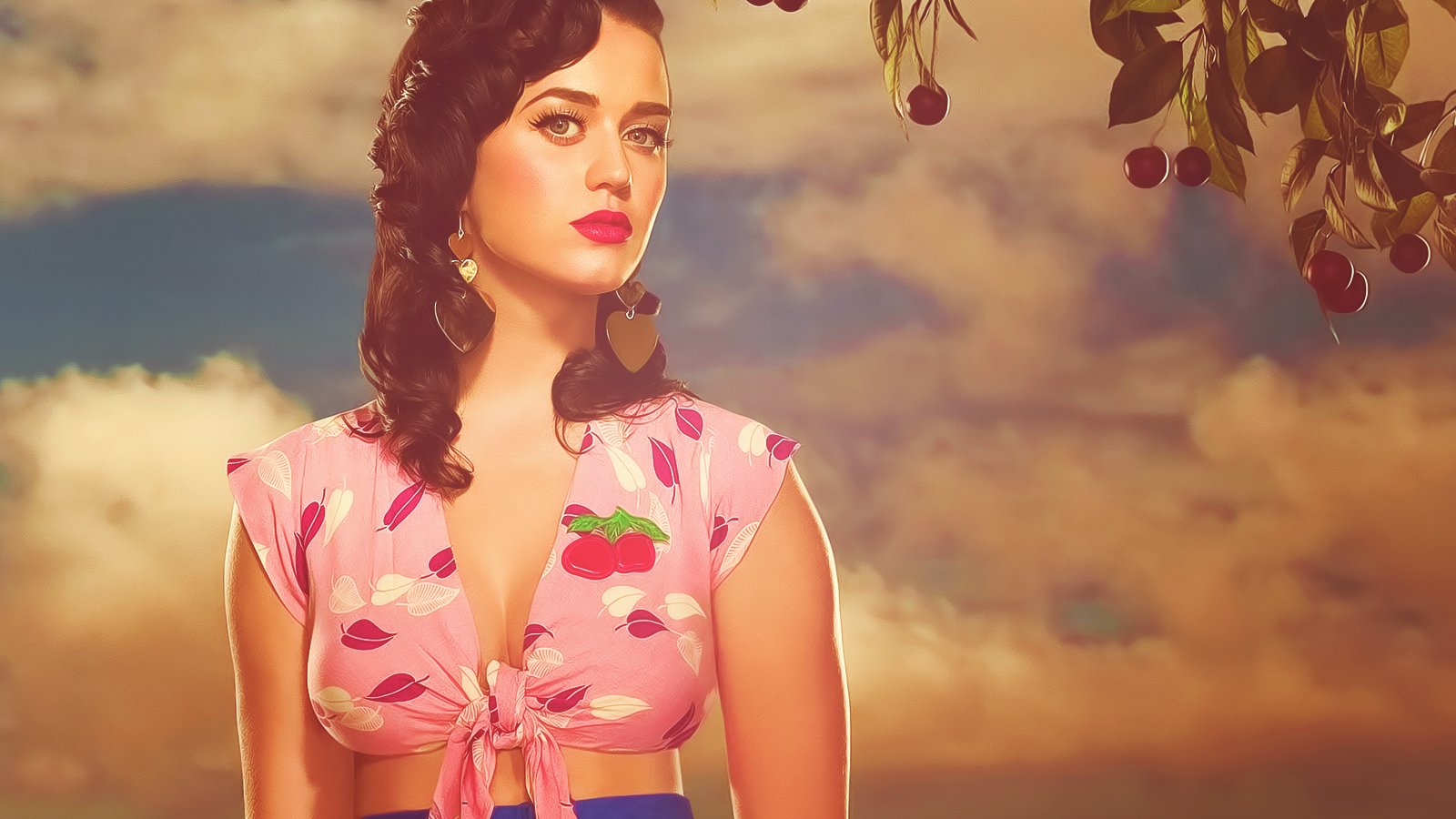 Katy Perry poses against a cloudy sky wearing a pink cherry-patterned top, blending music icon style with a vintage, dreamy atmosphere.
