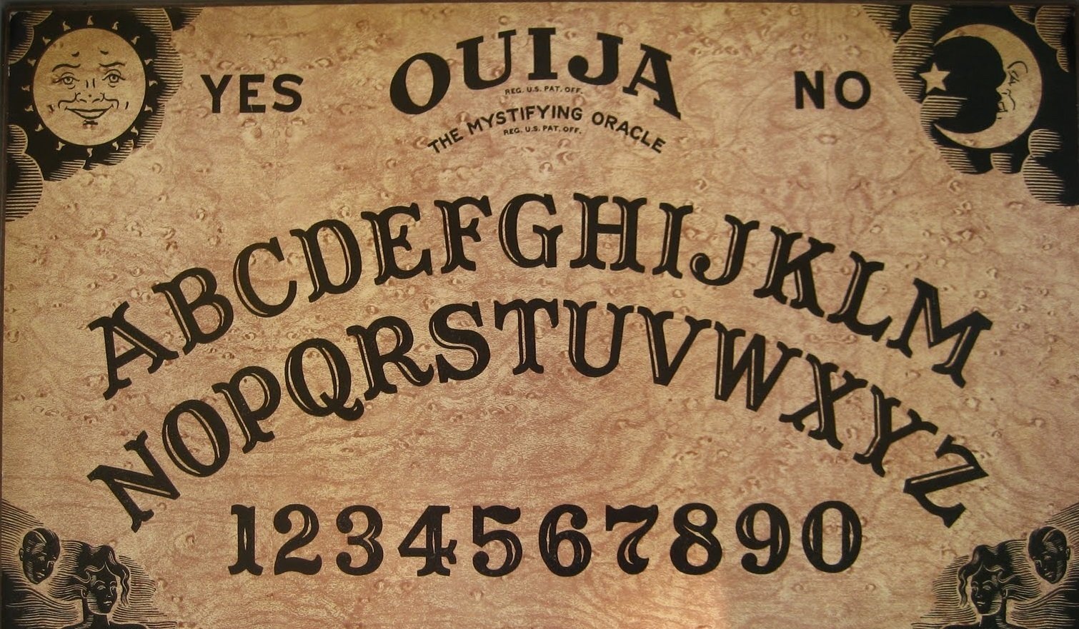 A close-up of a Ouija board featuring letters, numbers, and the words YES and NO, designed for spirit communication and divination.