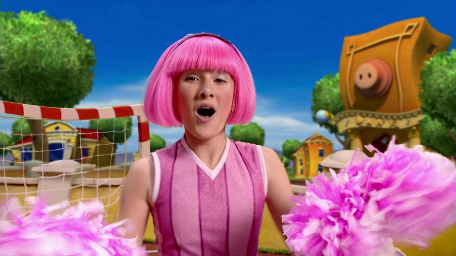 Stephanie from the TV show LazyTown cheering with pink pom-poms, wearing a pink dress and bob haircut in a bright outdoor playground.