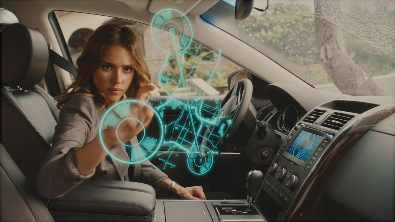 Jessica Alba in a car interacting with futuristic holographic controls, a scene from the movie Spy Kids: All the Time in the World.