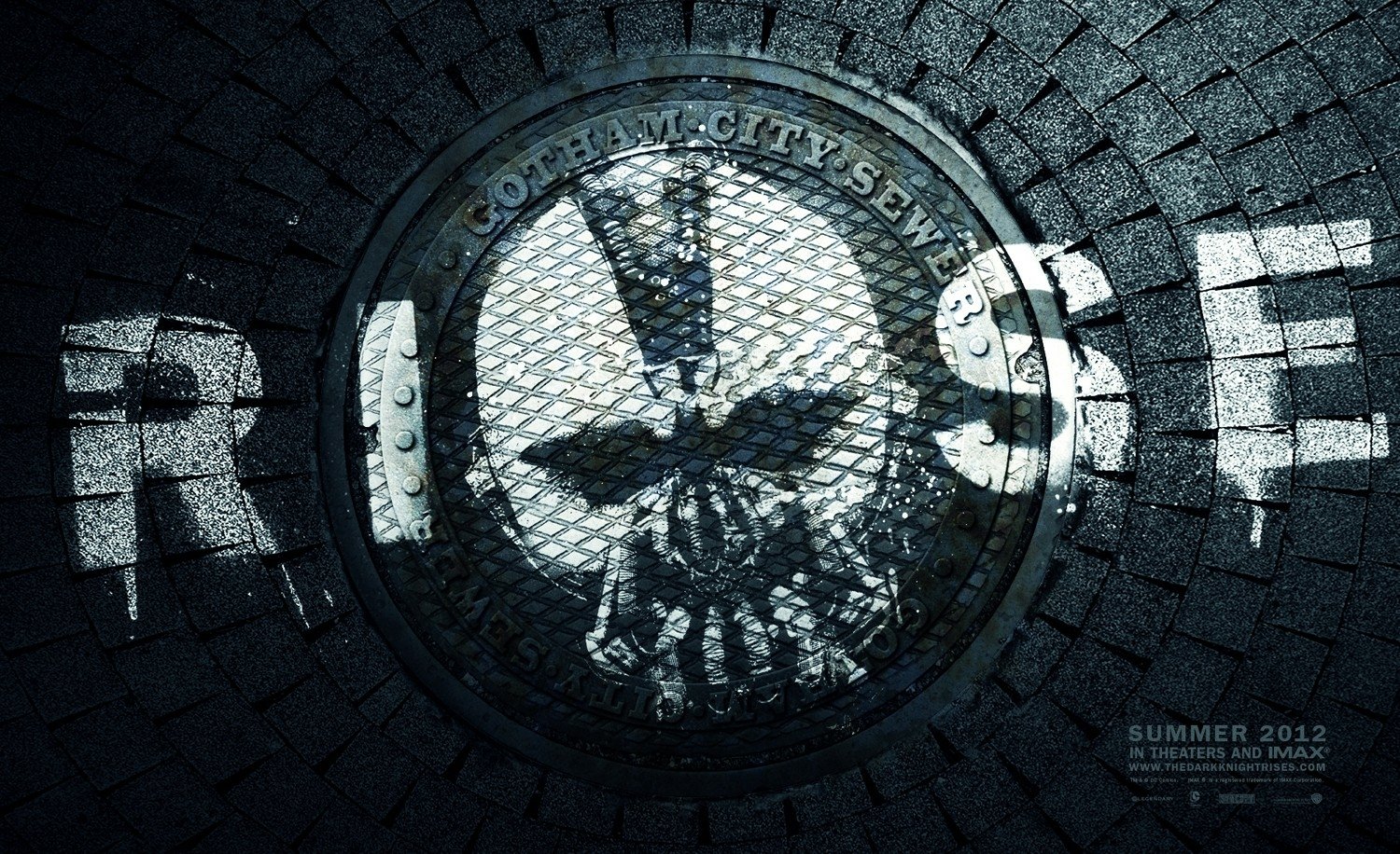 Manhole cover in a dark city street with the word RISE and a skull symbol, referencing the movie The Dark Knight Rises.