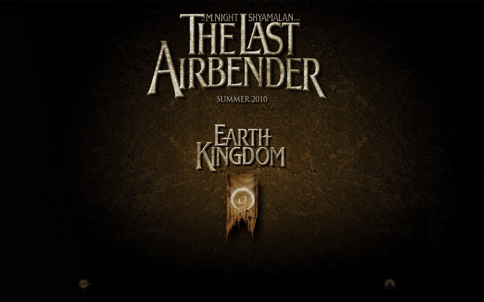 Title card for the movie The Last Airbender featuring Earth Kingdom text and symbol on a dark textured background.
