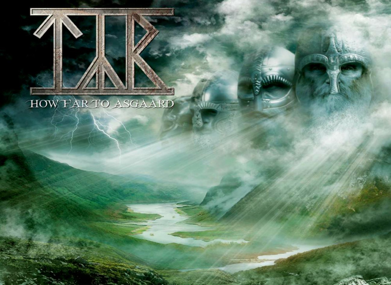 Album cover for the band Týr's music, featuring a mystical landscape with a winding river, stormy skies, and giant stone faces emerging from the mist.