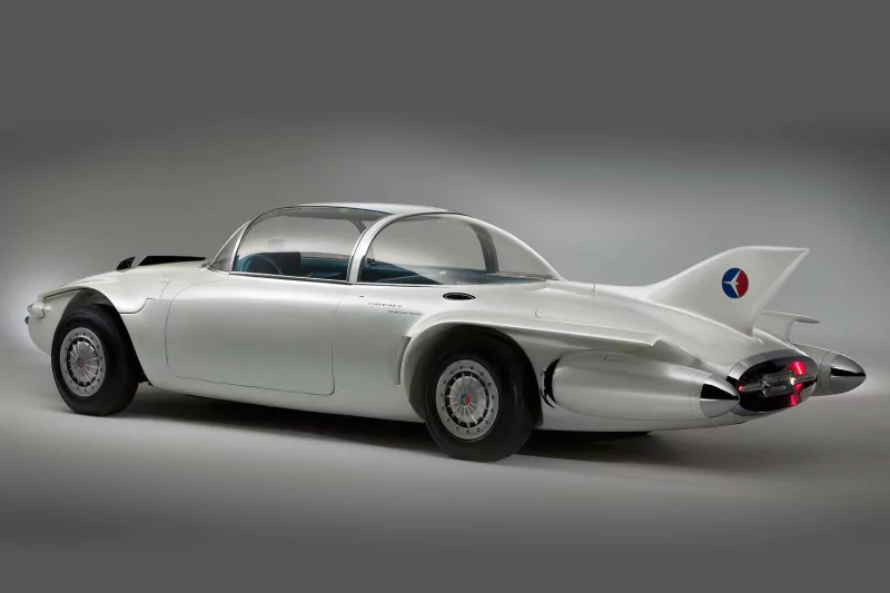 Sleek silver General Motors Firebird II concept vehicle with a futuristic design and prominent tail fins.