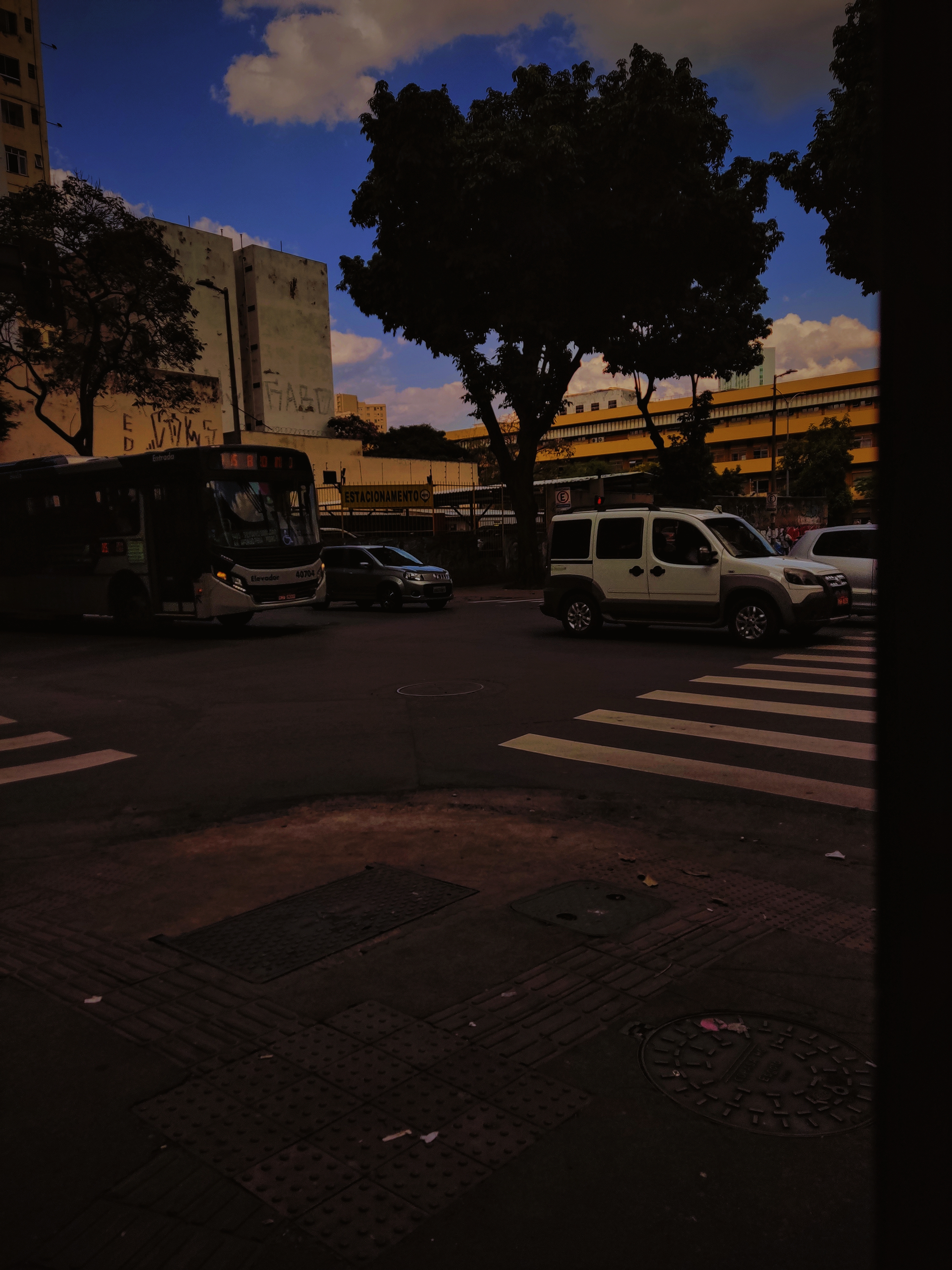 A street with cars and buses on it by Hermano006