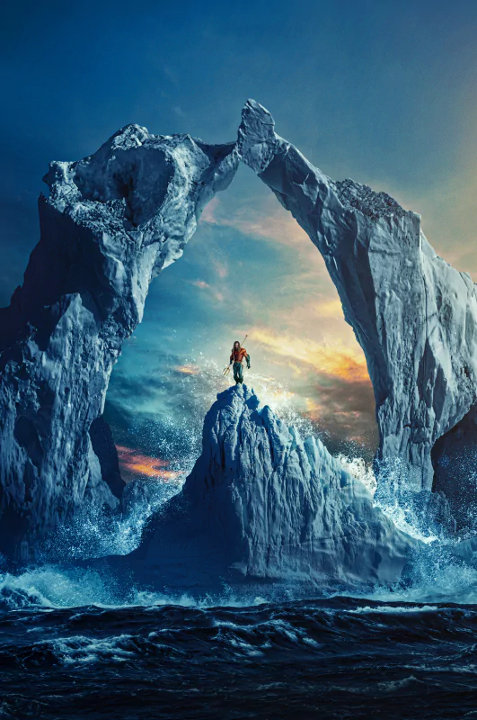 A lone figure stands on a rocky peak beneath massive, arching ice formations over turbulent waters in a scene from the movie Aquaman and The Lost Kingdom.