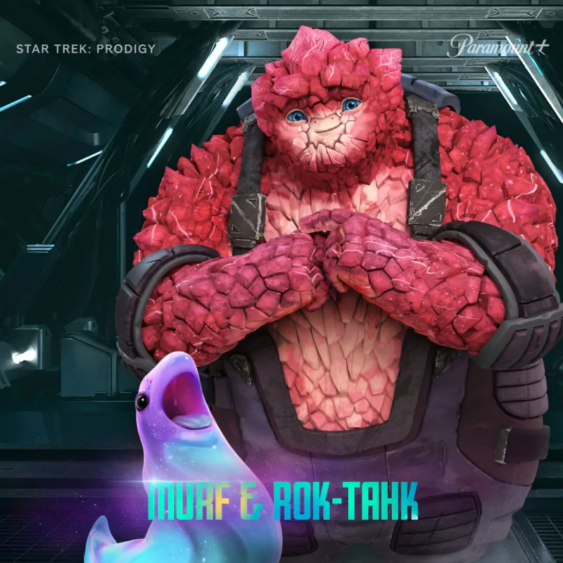 Promotional image featuring characters Murf and Rok-Tahk from the animated TV show Star Trek: Prodigy, with Rok-Tahk, a large rock-like alien, standing next to a cheerful purple creature.