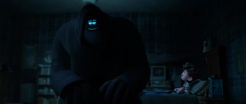 Animated scene from Orion and the Dark showing a child in bed facing a friendly giant shadowy figure.