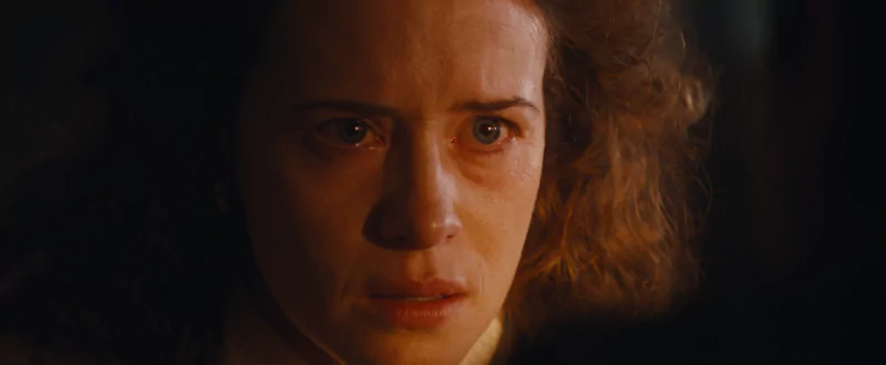 Tense close-up shot of a female character from the movie All of Us Are Strangers with a worried expression.
