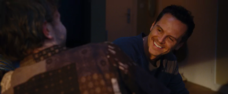A heartfelt scene from the movie All of Us Strangers featuring two characters engaging in an intimate conversation.
