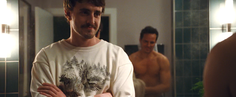 Man with a mustache in a white shirt standing in a bathroom with another person in the background, related to the movie All of Us Are Strangers.