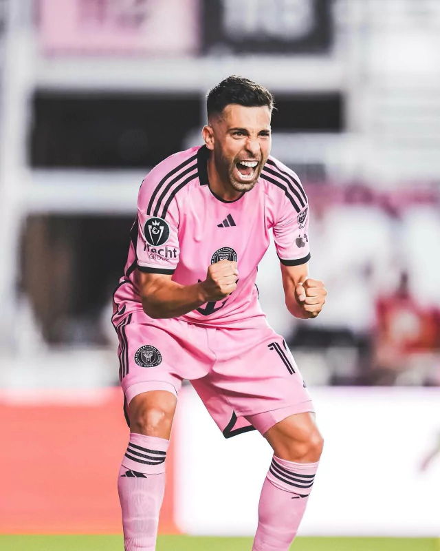 Excited soccer player from Inter Miami CF celebrating in a pink uniform on the field.