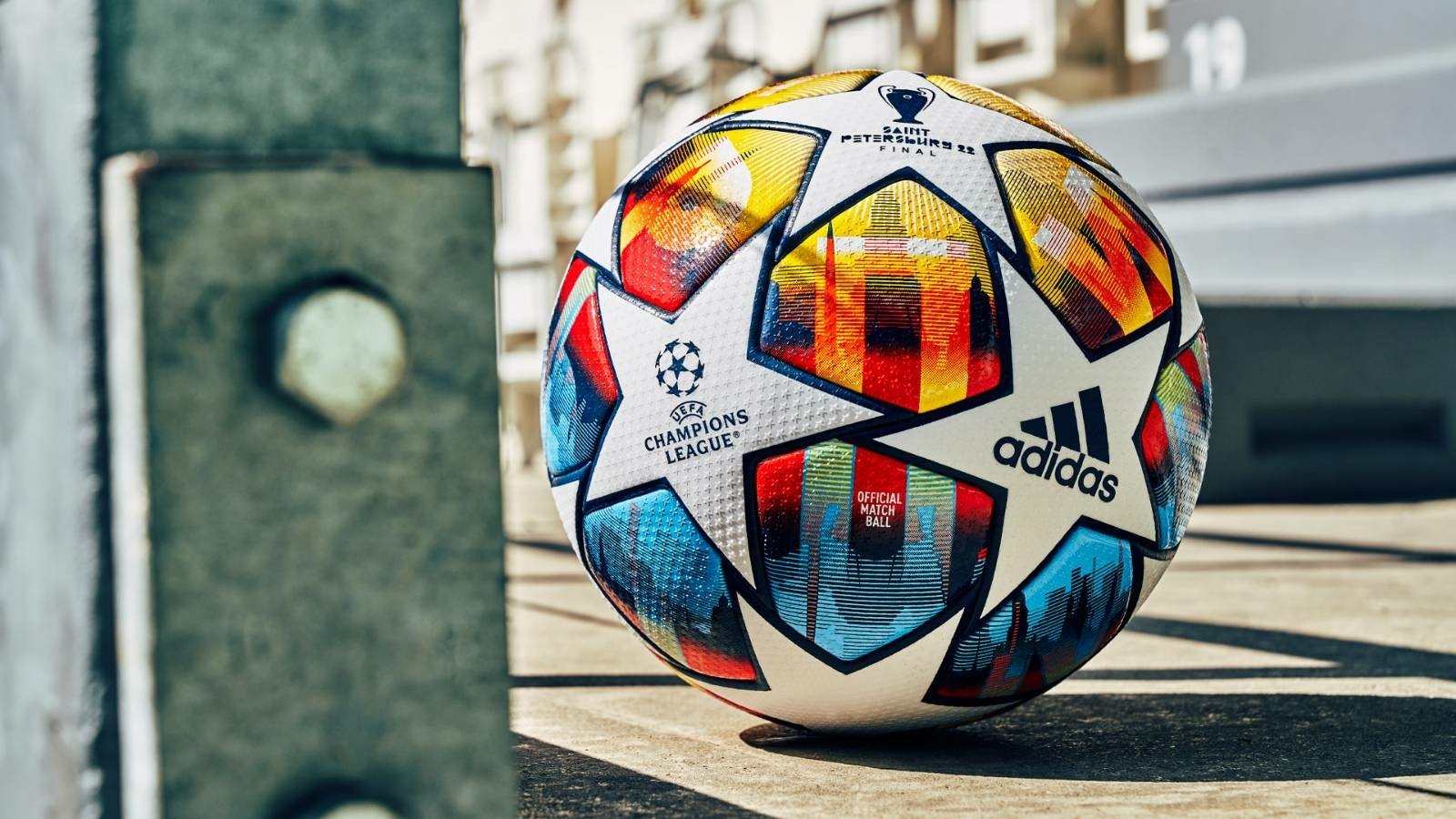 Official Adidas UEFA Champions League soccer ball placed on a city street.