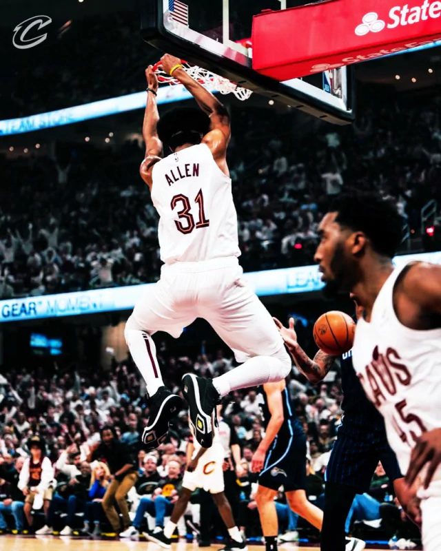 Cleveland Cavaliers player Allen (#31) executes a slam dunk during an NBA game as teammates and opponents watch intently.