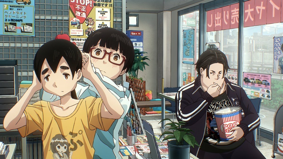 Three characters from the anime Dead Dead Demon’s Dededede Destruction stand in a cluttered room; one eats popcorn while the others appear flustered.