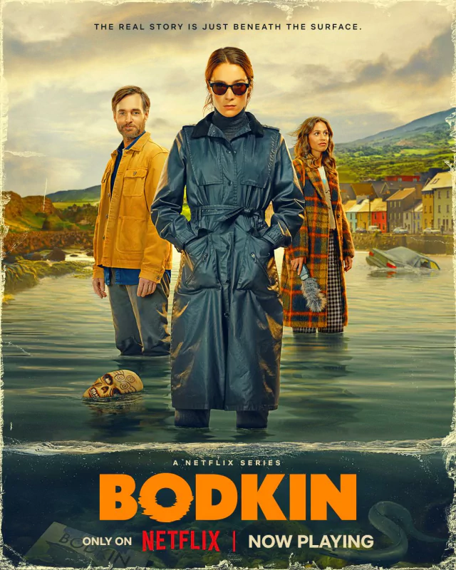 Poster for the TV show Bodkin featuring three characters standing in water with a coastal village backdrop, now streaming on Netflix.