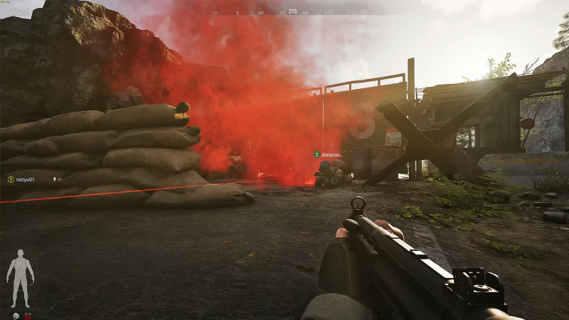 A first-person perspective in the video game Arena Breakout: Infinite, featuring a player aiming at a red smoke cloud near sandbags and a barricade in an outdoor environment.