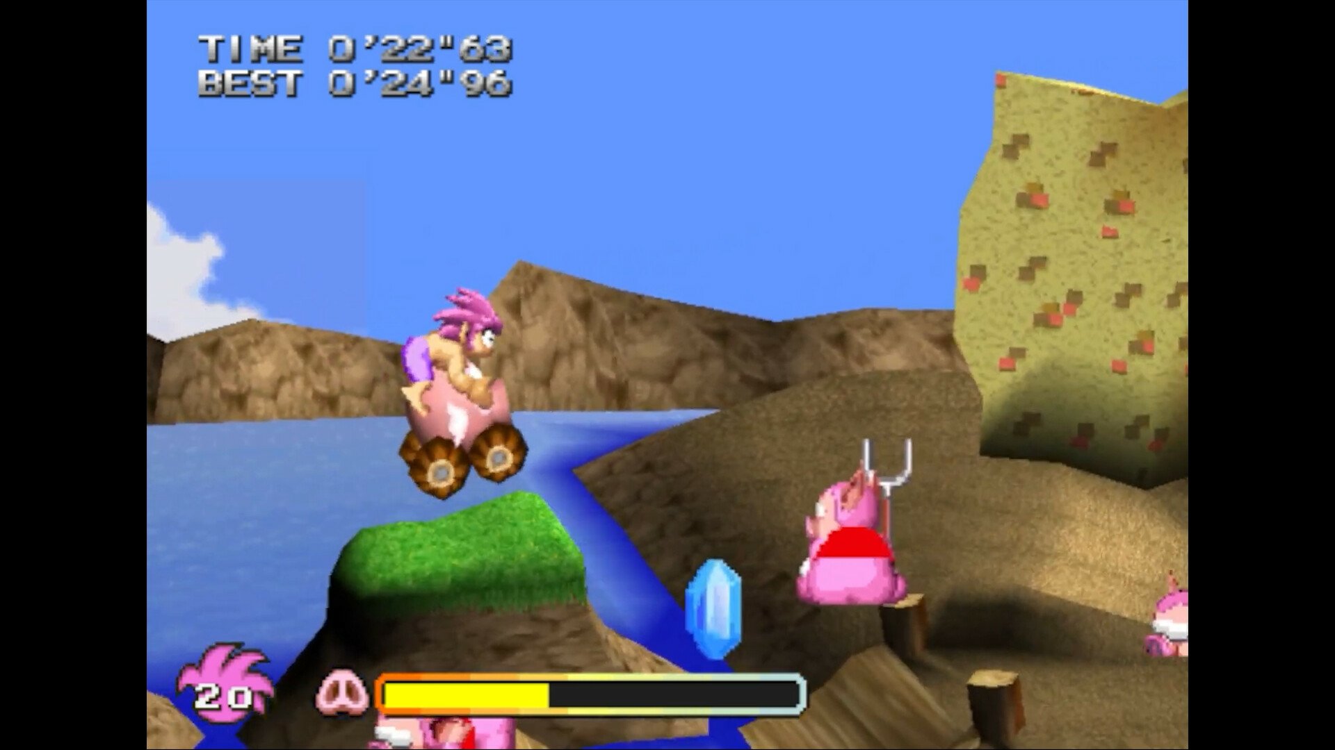 A colorful scene from Tomba! Special Edition, featuring a character on a vehicle navigating a landscape, with gems and obstacles in a vibrant, playful environment.