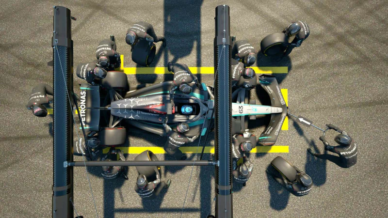 A top-down view of a Formula 1 car in a pit stop, surrounded by team members working efficiently, showcasing gameplay from F1 Manager 2024.
