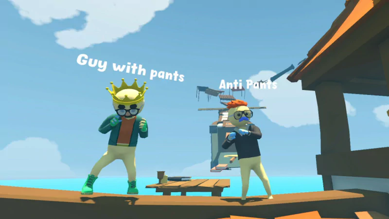 Two animated characters stand on a platform over water in a video game. One is labeled Guy with pants, while the other is humorously called Anti Pants.