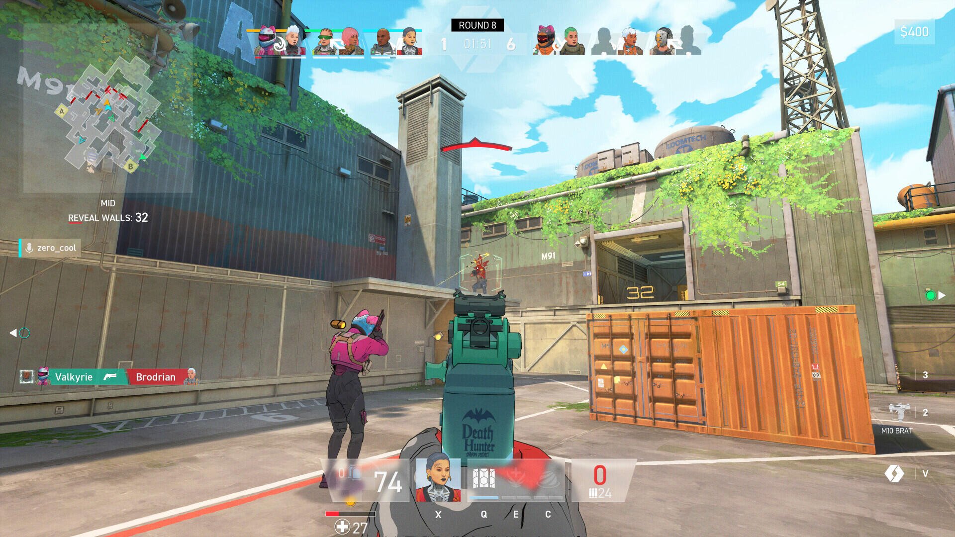 A player in a vibrant outfit aims a gun in the video game Spectre Divide, surrounded by an urban battle environment with crates and greenery in the background.