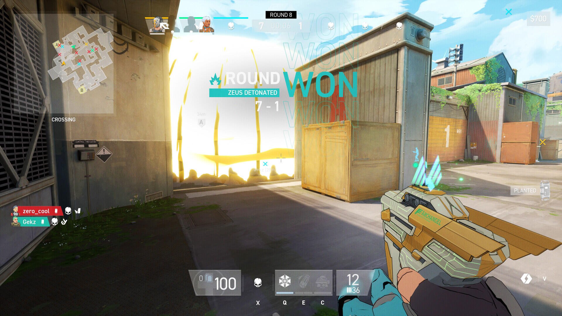 A player celebrates victory in the video game Spectre Divide, with ROUND WON displayed on screen. The character is ready for the next round, holding a futuristic weapon.