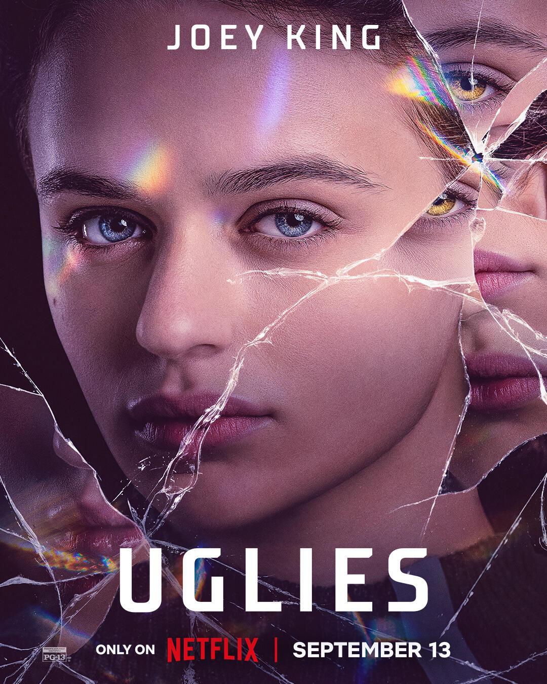 The image features the movie Uglies, starring Joey King, showcasing her face fragmented by shattered glass, highlighting themes of identity and beauty. Streaming on Netflix September 13.