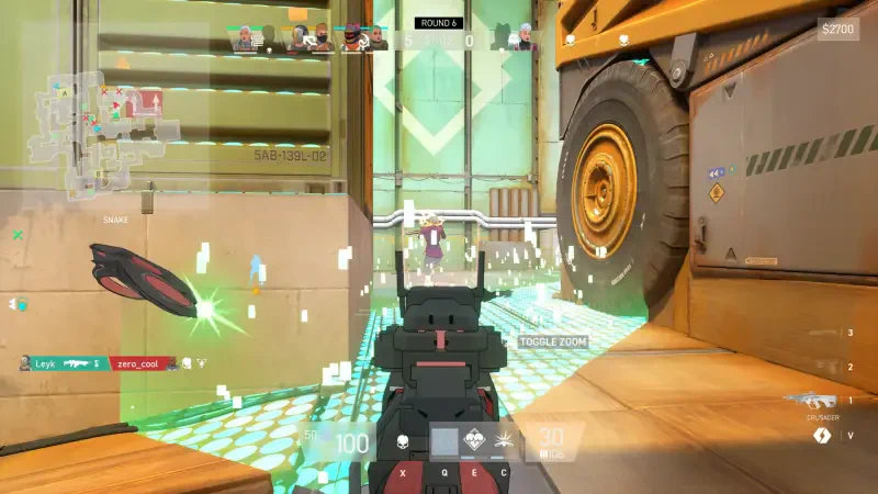 A player in the video game Spectre Divide aims their weapon, with an interactive game interface visible, surrounded by colorful effects and a partially obstructed environment.