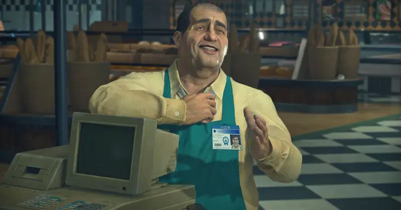 A cheerful character stands at a cash register in a bakery, wearing an apron and ID badge, from the video game Dead Rising Deluxe Remaster, showcasing a lively store environment.