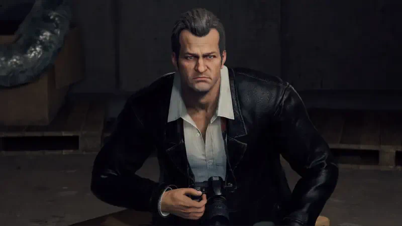 A character from the video game Dead Rising Deluxe Remaster is shown, featuring a man with a serious expression, wearing a black leather jacket and holding a camera.