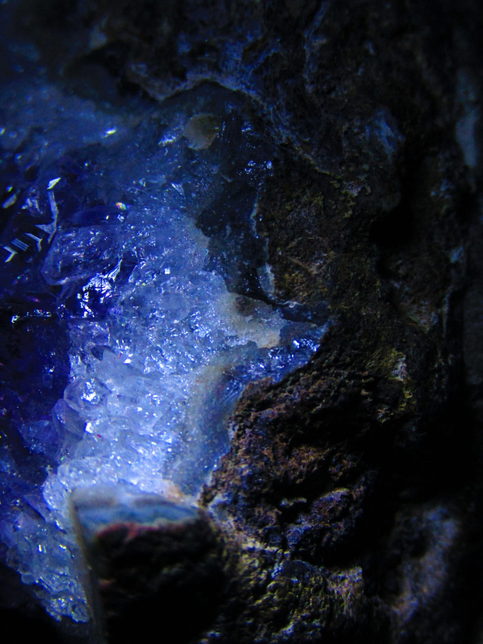 Amethyst geode rock crystal segment closeup with metal inclusions. by Demasc1